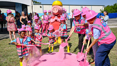 Kids in pink hardhats participated in the ceremonial groundbreaking for the Peppa Pig Theme Park.